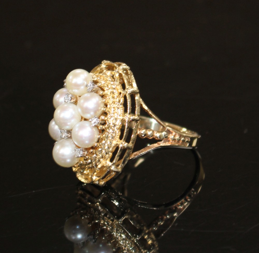 A modern 14k yellow metal, cultured pear and diamond cluster set oval dress ring, size P, gross weight 9.2 grams.